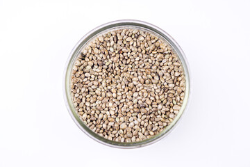Cannabis seeds in glass bowl isolated on white