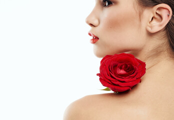 sexy woman with red flower on shoulder on light background cropped back view