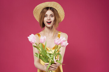 Woman in golden dress bouquet of flowers gift holiday pink background