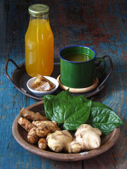 Ginger, turmeric, betel leaves in earthen plate as jamu or Indonesian herbal drink ingredients....
