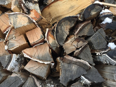 Birch wood darkened from old age piled into a lyd