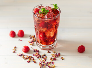 Cold Brew Hibiscus Ice Tea with raspberry and mint. Selective focus, shallow depth of field.