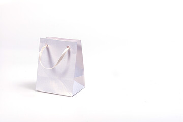 white paper shopping bag isolated on light background, mockup for design