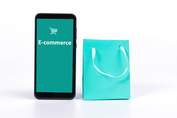 smartphone and colourful paper bags isolated on bright background, mockup for design