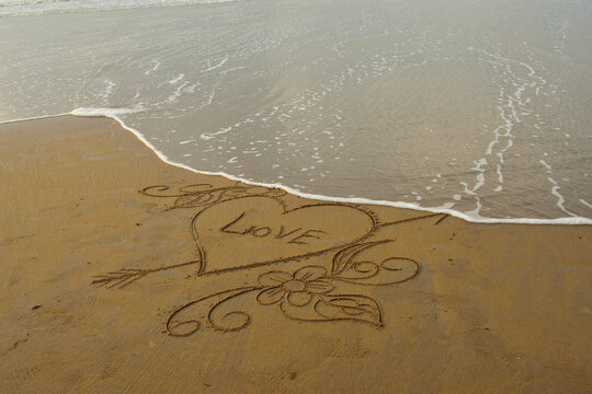 Hand drawn heart on beach. Romantic composition. a romantic background with copy space