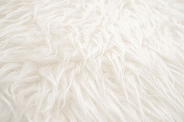 Close up shot of white fake fur fabric with blur effects.