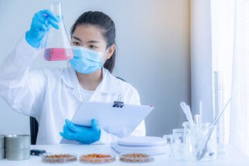 Quality control personnel are inspecting the chemical quality pet food. Quality of human food and...