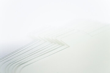 Close up shot of a pile of white thick papers for headband in eyelash extension treatment.