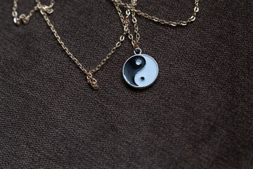 Fototapeta na wymiar Yin Yang pendant necklace handmade black and white closeup. Selective Focus. High quality photo