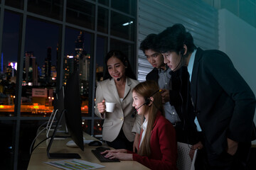 Selective Focus. Team telemarketers operators working late at night in a call center. Technical, Customer service use a headset to answering customer questions. Telemarketing Communication support.
