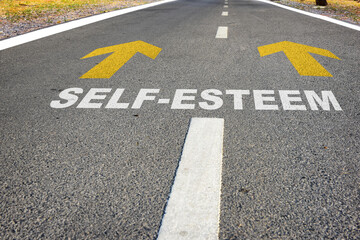 Self-esteem and yellow arrow sign marking on road surface for giving directions. Boosting self...