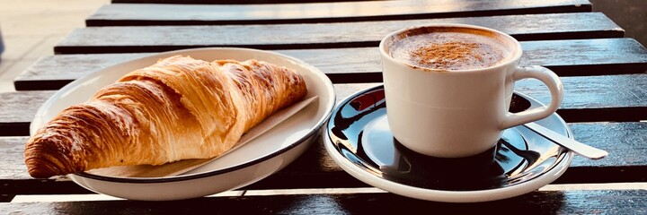 cup of coffee and croissant banner