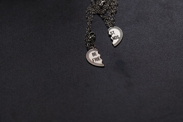 Pendant of best friends heart in two parts necklace closeup. Selective Focus. High quality photo