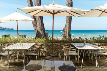 Outdoor cafe exterior on the beach with sea view.