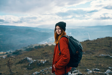Obraz premium portrait of a traveler in the mountains in nature rock landscape clouds sky model