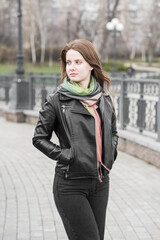 Portrait of a young girl who poses while walking in cloudy weather