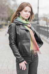 Portrait of a young girl who poses while walking in cloudy weather