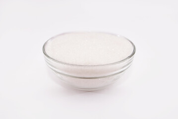 Sugar - sand in a glass bowl on a white