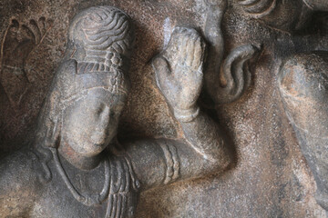 Fragment of stone decadations on the walls of an ancient Hindu temple in India.