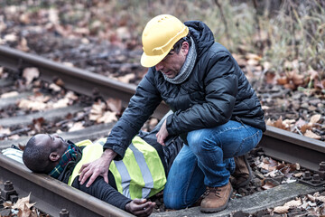 African American railroad engineer injured in an accident at work on the railway tracks. Coworker...