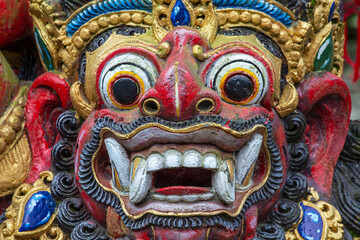 Fototapeta na wymiar Traditional Balinese demon statue in the street temple. Island Bali, Indonesia
