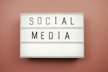 Social Media word in light box on pink background