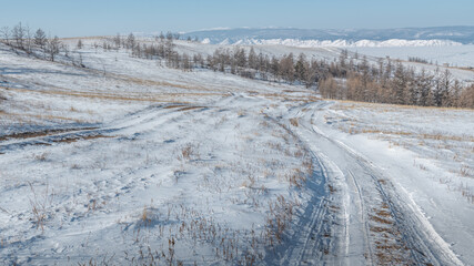 Winter road on snow-covered hills