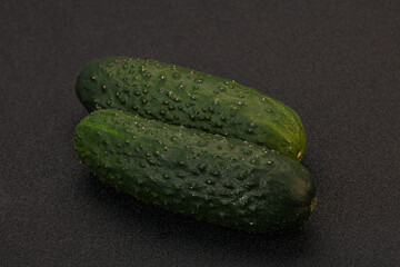 Green fresh cucumbers over background