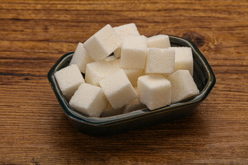 Refined white sugar cubs in the bowl