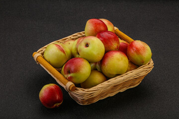 Sweet small nectarines in the basket