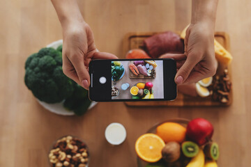 Photo of variety of foods being taken on a smartphone