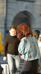 The people taking photos on the street in the afternoon with the warm sunlight