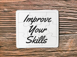 Business concept. Phrase improve your skills written on puzzle board.