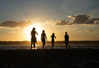 Silhouette of Family Playing on the Beach at Sunset