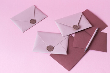 pink envelopes with letter on a pink background