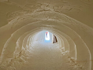 Tunnel dug through deposits of fresh snow above the Glacier du Sex Rouge in the alpine mountain...