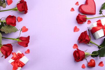 Flat lay composition with beautiful red roses and gift boxes on violet background, space for text. Valentine's Day celebration