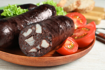 Tasty blood sausages served on white wooden table, closeup