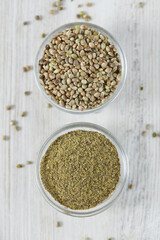 hemp powder in a bowl on white wooden surface