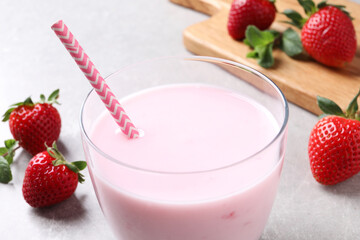 Delicious strawberry drink on light grey table, closeup