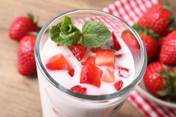 Delicious drink with strawberries on table, closeup