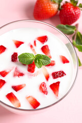 Yummy drink with strawberries in glass, closeup