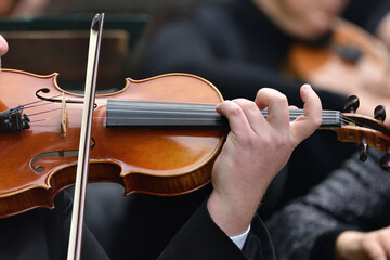 violin during a concert , with hands and a bows 