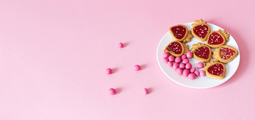 pink candy and cookies on a pink background