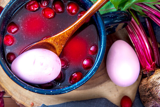Homemade painting Easter eggs with natural beet and cranberries. Non-toxic coloring