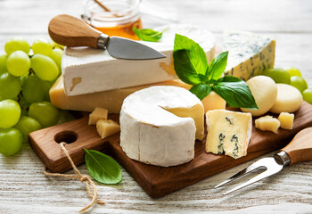 Various types of cheese  on a white wooden  background