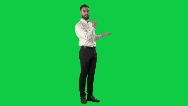 Young silent business man presenting strategy and demonstrate on business meeting. Full length on green screen chroma key background.
