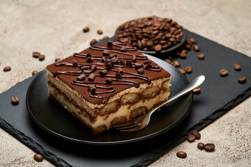 Portion of Traditional Italian Tiramisu dessert on grey concrete background