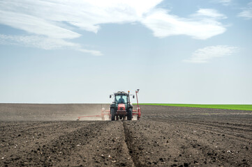 Sowing crops at agricultural fields in spring