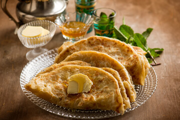 traditional morocco bread wih butter honey and mint tea - 428363869